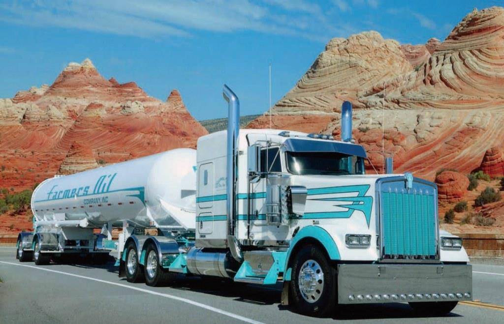 Highway Vacation, a white and teal Farmers Oil Kenworth with a propane transport, among red sandstone formations